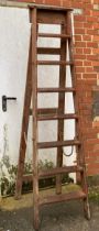 A large vintage wooden stepladder