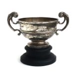 A large silver twin handled trophy cup on turned ebonised base, by Walker & Hall, Sheffield 1904,
