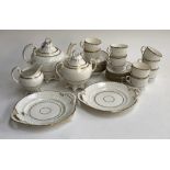 A porcelain tea service, pink dot design heightened in gilt, 23 pieces, comprising cake plates,