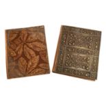 An Art Nouveau pressed brass wallet, 28x22cm; together with a further floral pressed wallet