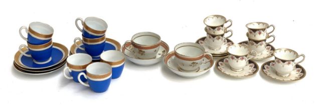 A quantity of teacups and saucers to include 19th century pair with orange band and gilt spray