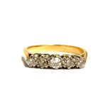 A gold and diamond five stone ring, unmarked but tests as 18ct, one stone chipped, size L, 2.8g