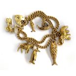 An 18ct gold twin row curb link charm bracelet with heart padlock with a collection of 9ct gold