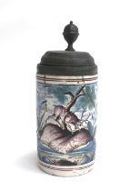 An 18th century majolica tankard with pewter cover (af), depicting a stag amongst cyprus trees,