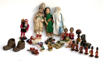 A quantity of vintage souvenir dolls and wooden figurines