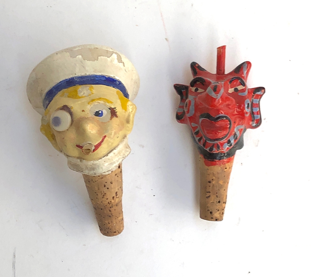 Two early 20th century papier mache novelty bottle stoppers, in the form of a sailor and a devil