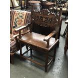 A carved oak throne chair, the back with central inlaid panel, 65cmW