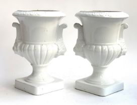 Interior design interest: A pair of large white glazed ceramic twin handled urns with mask detail,