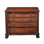 A George III style serpentine chest of drawers, having a slide over four graduating drawers each