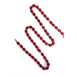 A long string of cherry amber red bakelite type beads, the 54 beads each approx 1.6cm long, 130g