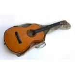 A classical guitar with soft carry case