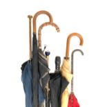 A mixed lot of vintage umbrellas (some af), one with chased white metal handle, one art deco with