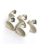 A set of five ceramic fishing fly napkin rings