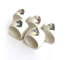 A set of five ceramic fishing fly napkin rings