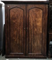 A large 19th century mahogany wardrobe, with out jutting pediment, two panelled doors opening to