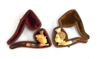 Two 19th century meerschaum pipes in fitted cases, one in the form of a lady in a bonnet, 11cmL;