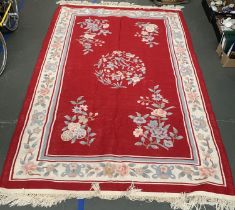A large red ground wool rug, approx. 293x187cm