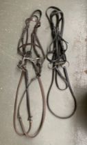 A full size snaffle exercise bridle; and a leather bridle (2)