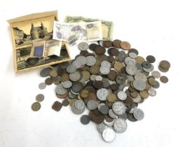 A quantity of British and World coins and banknotes to include Ireland, England, Scotland £1