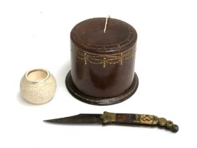 An embossed leather string box, 8.5cmH; together with a Toledo steel pocket knife; and a Macintyre