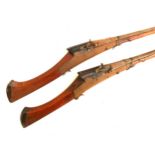 A pair of 19th century Indian matchlock muskets, the barrel 108cm long, the steel barrel engraved