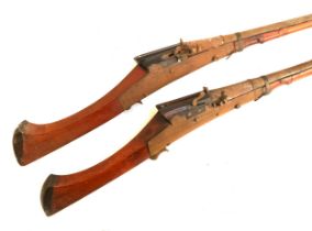 A pair of 19th century Indian matchlock muskets, the barrel 108cm long, the steel barrel engraved