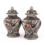 A pair of Chinese crackle glaze famille rose jars and covers, 19th century, each 35cm high