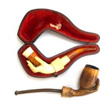 Two meerschaum pipes in the form of a hand, one in a fitted case, 10.5cmL and 12.5cmL