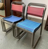 A set of six stacking tubular metal and canvas village hall chairs