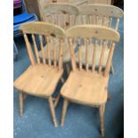 A set of four spindle back pine kitchen chairs