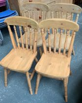 A set of four spindle back pine kitchen chairs