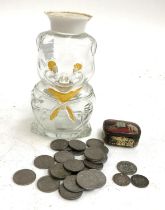 A small quantity of coins to include threepence 1887, 1902, sixpence 1939, in novelty glass piggy