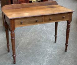 An early 20th century mahogany writing table with two frieze drawers, on turned legs, 105x51x74cmH