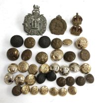 A quantity of military buttons and cap badges to include the Dorset Regiment, North Staffordshire,