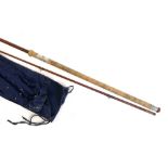 A 9'10" two piece glass fibre rod, "The Carp", with cork handle, in bag