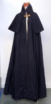 A late 19th/early 20th century dark navy regimental cloak with red velvet lining and gilt metal