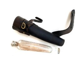 A conical glass hunting flask, in leather holster with saddle furniture, 26cm long