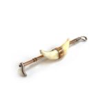 An early 20th century 9ct gold and silver bar brooch in the form of a whip with mounted fox teeth,