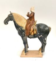 A good reproduction Tang style horse and rider, 28cm high
