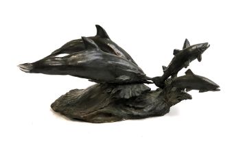 A cold cast bronze resin figure group of two dolphins chasing salmon, 51cmL