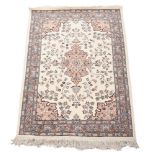 A heavy wool and cotton cream ground rug, Iran, approx. 124x215cm