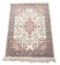 A heavy wool and cotton cream ground rug, Iran, approx. 124x215cm