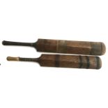 A pair of vintage cricket bats: 'The Champion' by Stuart Surridge & Co, and 'The Marathon' by