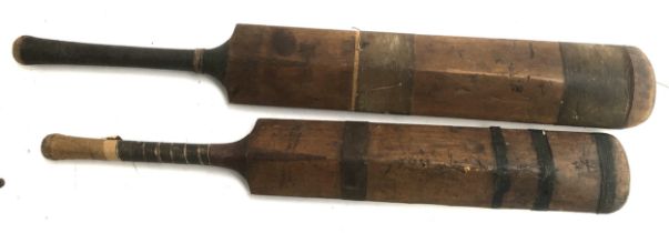 A pair of vintage cricket bats: 'The Champion' by Stuart Surridge & Co, and 'The Marathon' by
