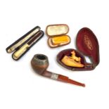 A small meerschaum pipe carved with a horse; together with a gold mounted amber cheroot holder in