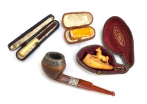 A small meerschaum pipe carved with a horse; together with a gold mounted amber cheroot holder in