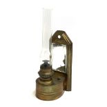 Local Interest: A wall mounted brass oil lamp, with glass chimney and bevelled mirrored plate,