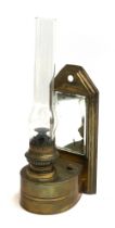 Local Interest: A wall mounted brass oil lamp, with glass chimney and bevelled mirrored plate,