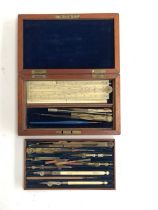 A set of drawing instruments marked Elliott, in a mahogany case with brass plaque inlay; together