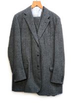 A Redmayne Cumbria three piece herringbone tweed suit with blue windowpane check, c.1992, the